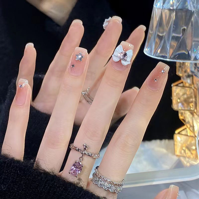 Artistic nail tips with floral and glittering accents Kalsten