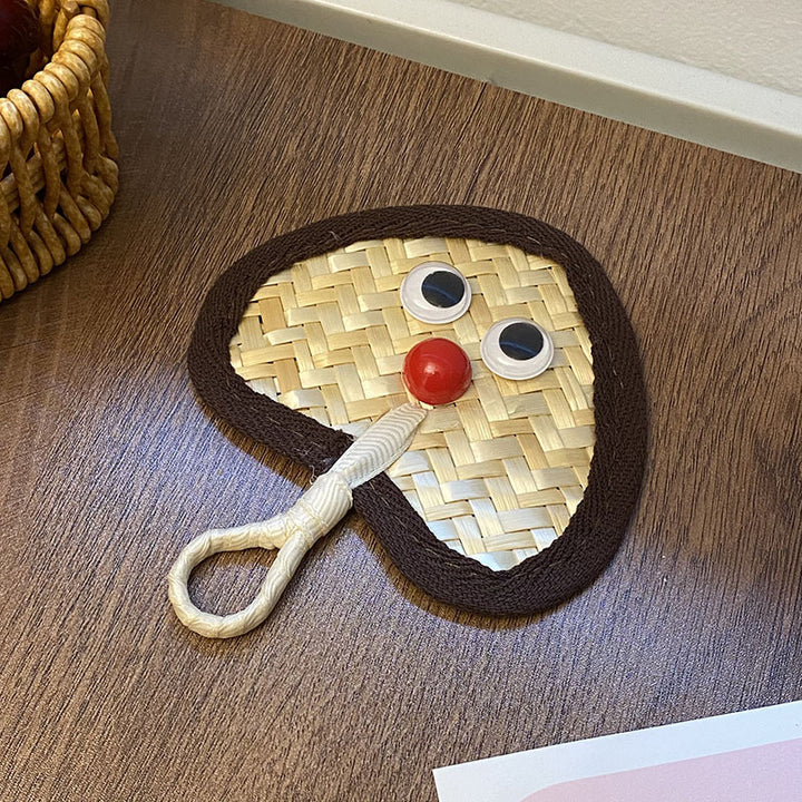 Handcrafted fan with playful face motif Kalsten