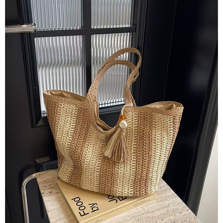 Handcrafted straw bag with elegant tassels and detailed texture Kalsten