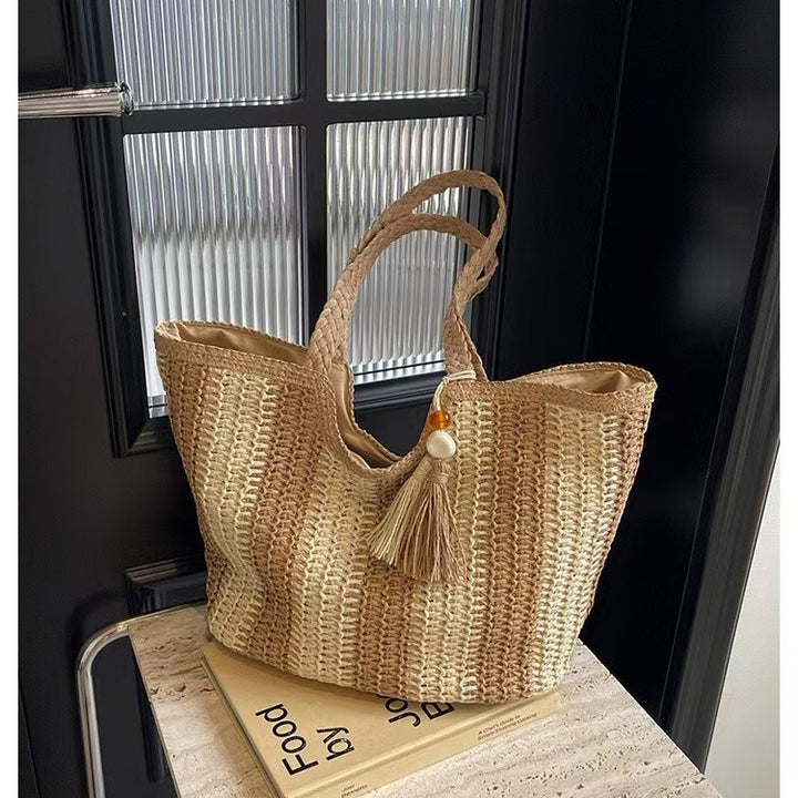 Handcrafted straw bag with elegant tassels and detailed texture Kalsten