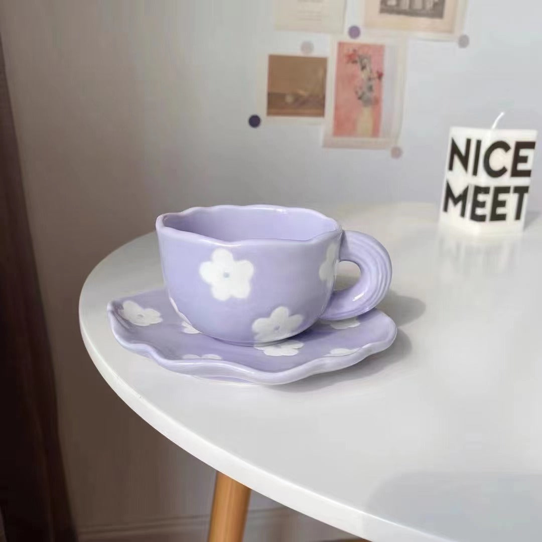 Ceramic coffee set with playful bear reliefs and organic wave saucer