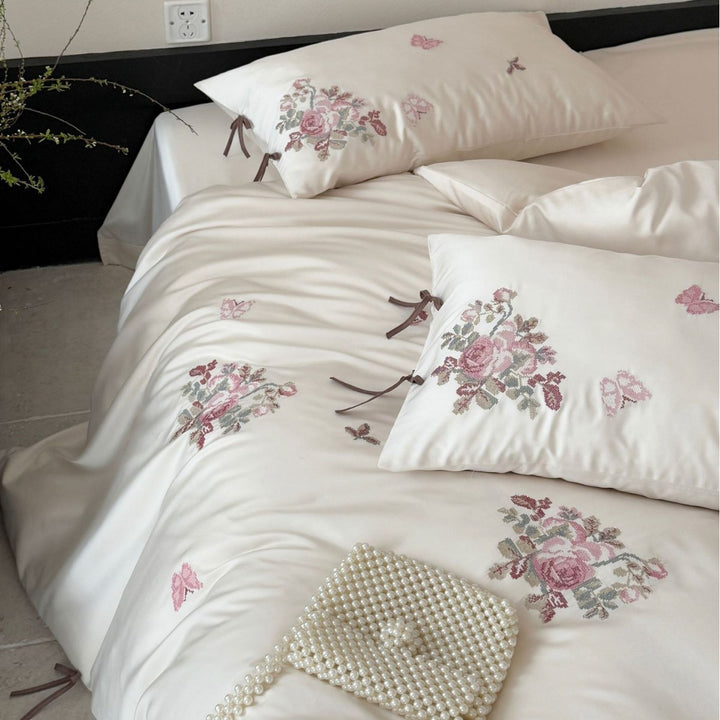 Silky-matte satin bedding set with embroidered rose bouquets and ties