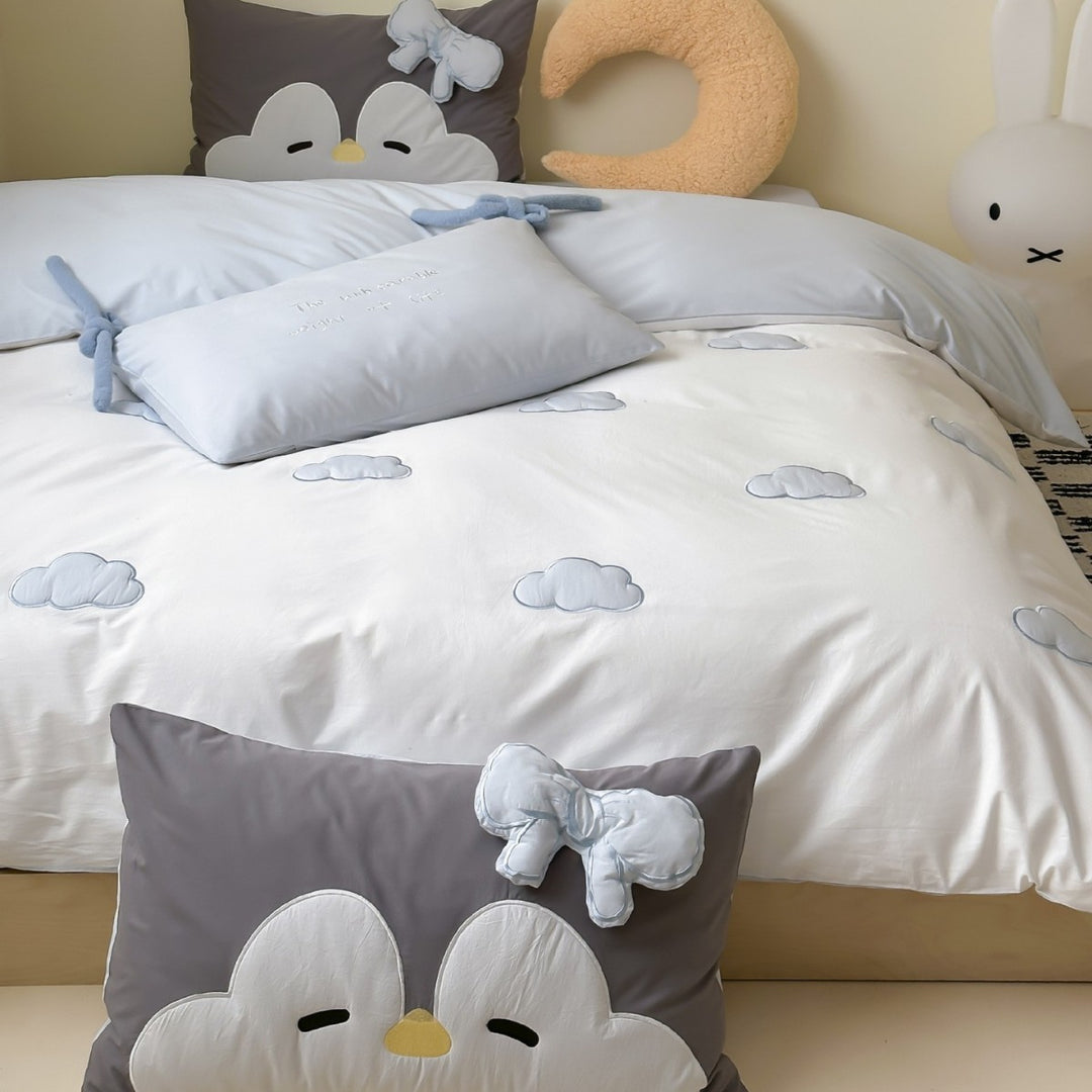 Children's bedding set with embroidered sprinkle appliqués, cuddle pillow and reversible function