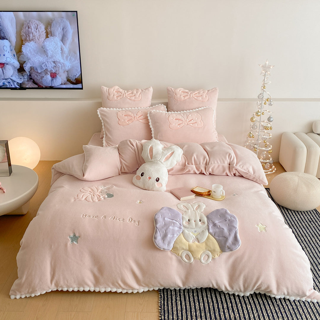 Cozy quilted bedding set with plush appliqué and pompom trim