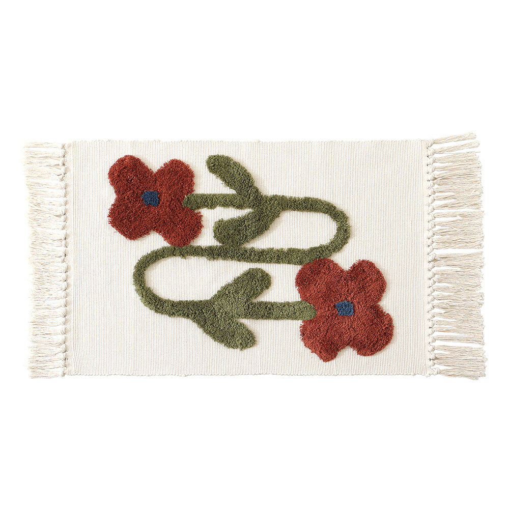 Decorative cotton bath mat with fringes and textured floral border