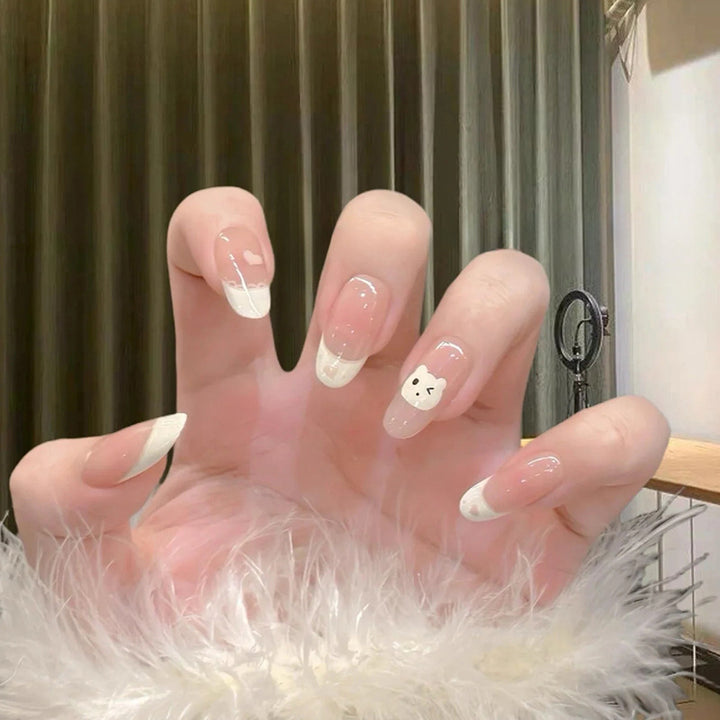 Artificial nails with playful animal motif and elegant French tip design Kalsten
