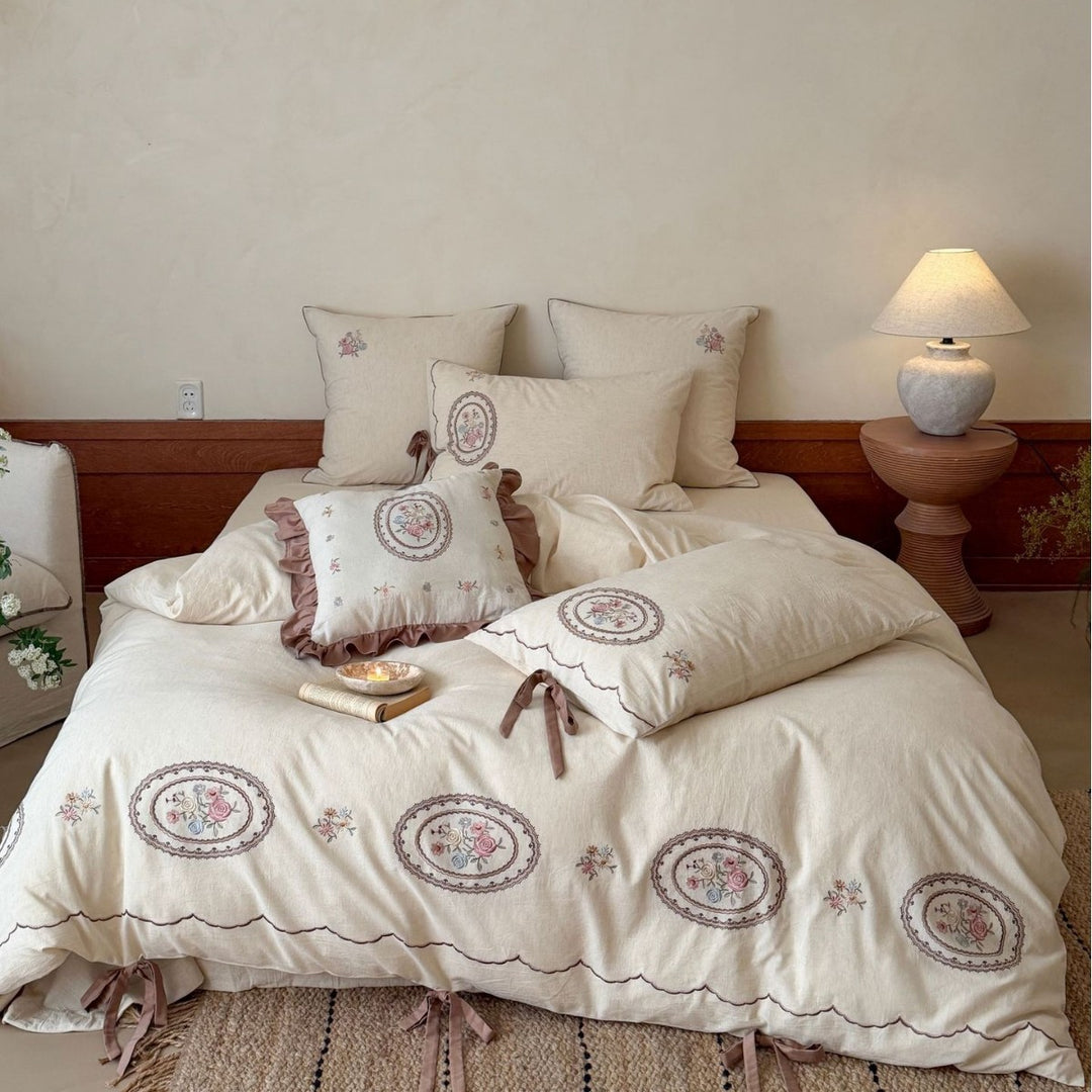 Romantic cotton-linen bedding set with embroidered flower medallions and ruffles
