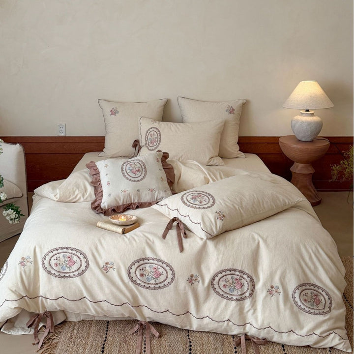 Romantic cotton-linen bedding set with embroidered flower medallions and ruffles