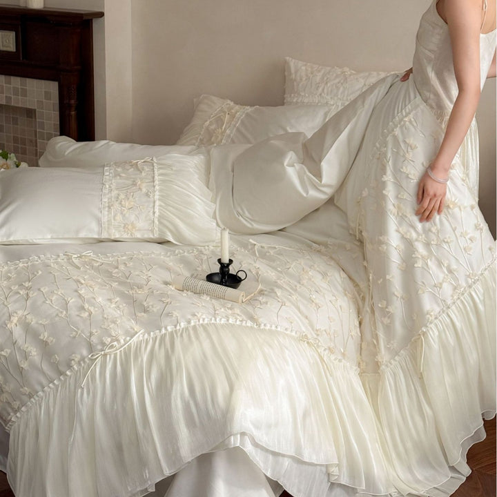 Embroidered bedding set with ruffles and three-dimensional flower appliqués