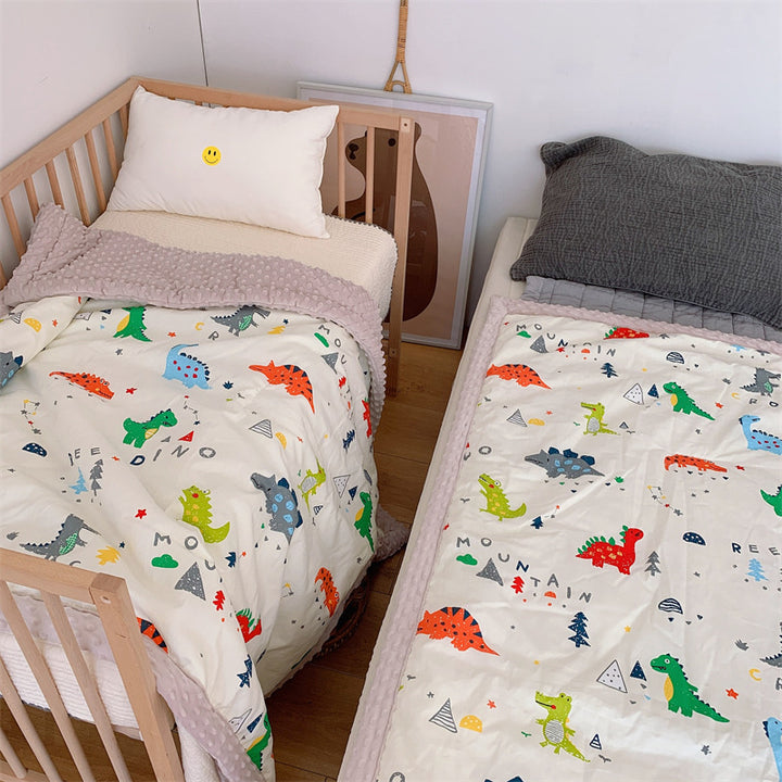 Children's quilt with colorful dinosaur print and soft minky border