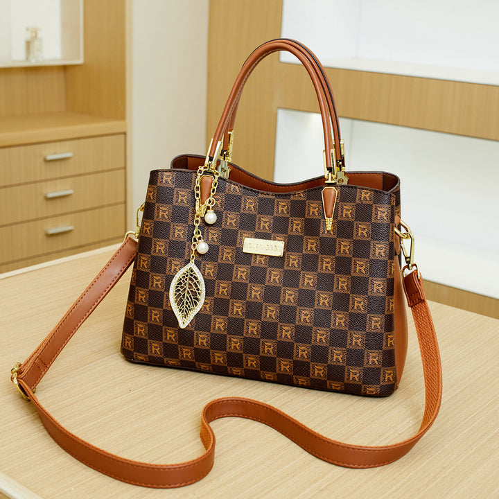 Elegant Designer Handbag with Decorative Charm