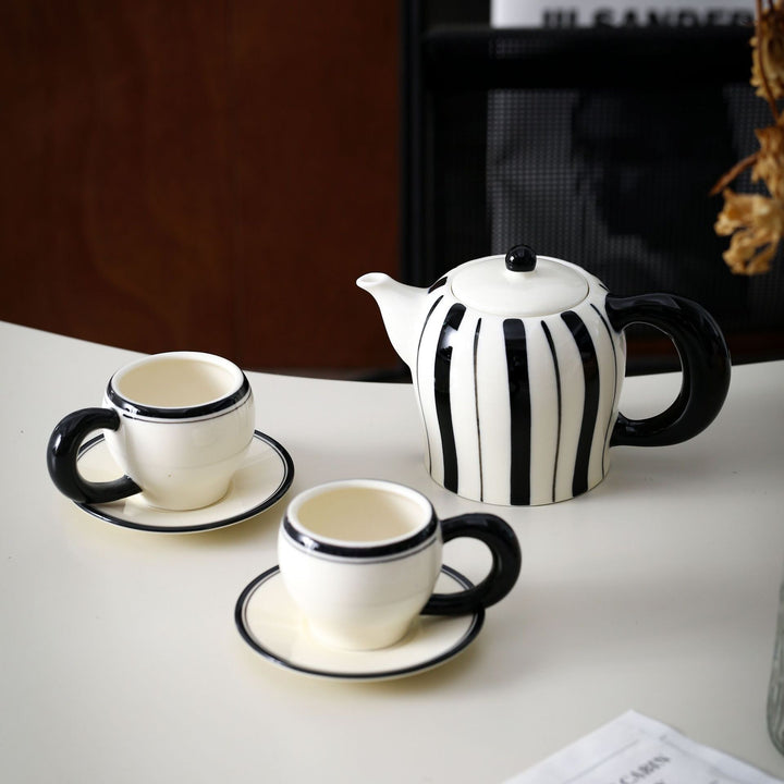 Porcelain tea set with vertical stripe decor and ergonomic handles
