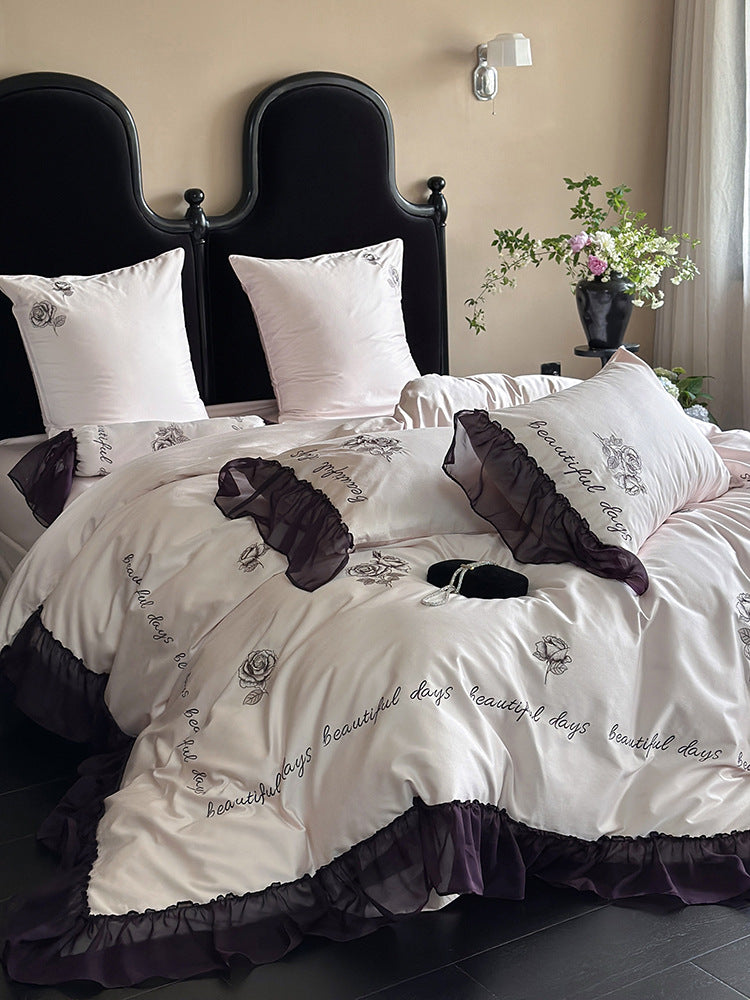 Bedding set made of silky-soft cotton satin with ruffle, delicate rose embroidery, and decorative lettering