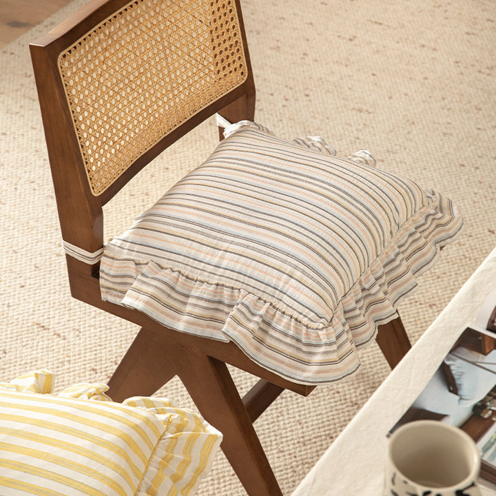 Striped chair cushion with ties, ruffled hem and linen look