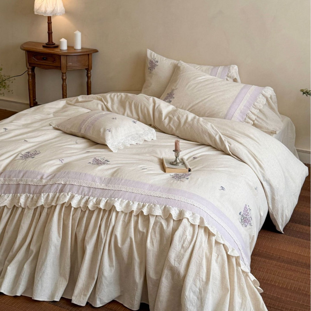 Vintage-inspired bedding set with ruffled bed skirt and delicate floral embroidery