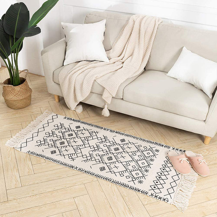 Woven cotton rug runner with flat weave structure, graphic diamond ethnic pattern and fringes