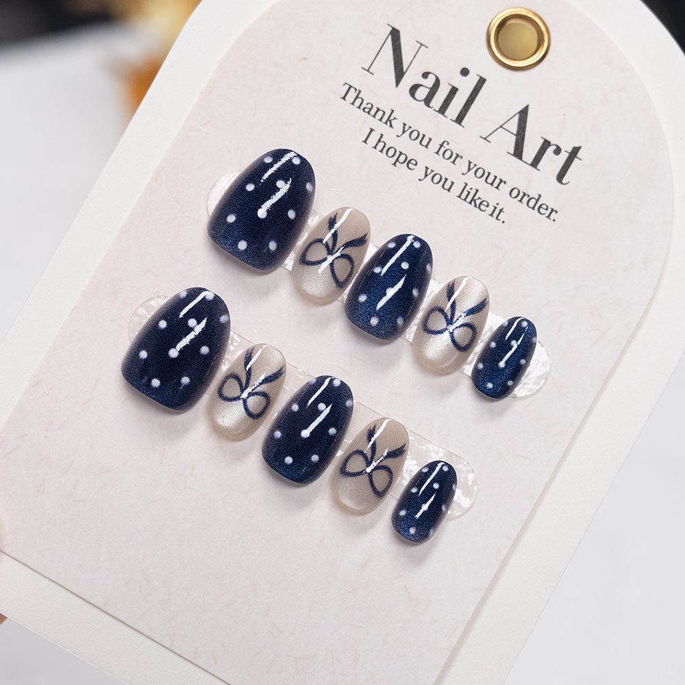 Decorative Nail Art with Bow and Polka Dot Design