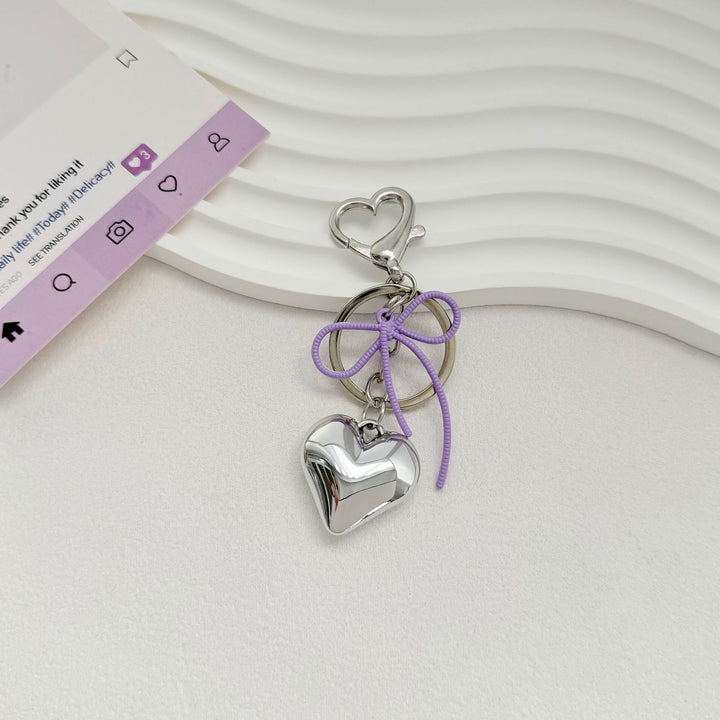 Heart-Shaped Metallic Keychain with Decorative Bow Kalsten