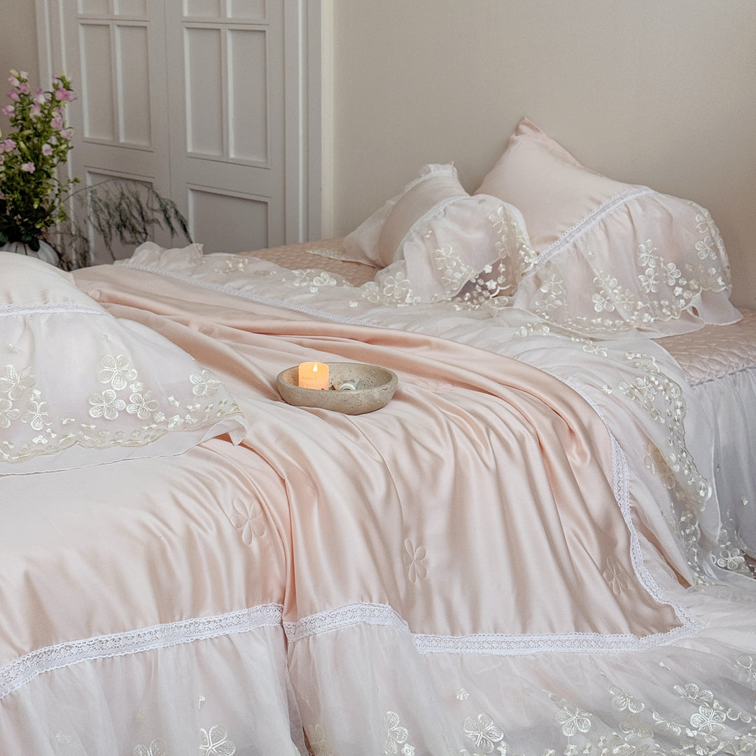 Satin bed linen set with embroidered chiffon ruffle and quilted bedspread