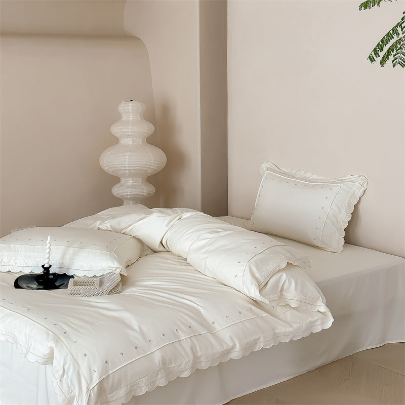 Bedding set made of cotton satin with fine star embroidery and wave hem