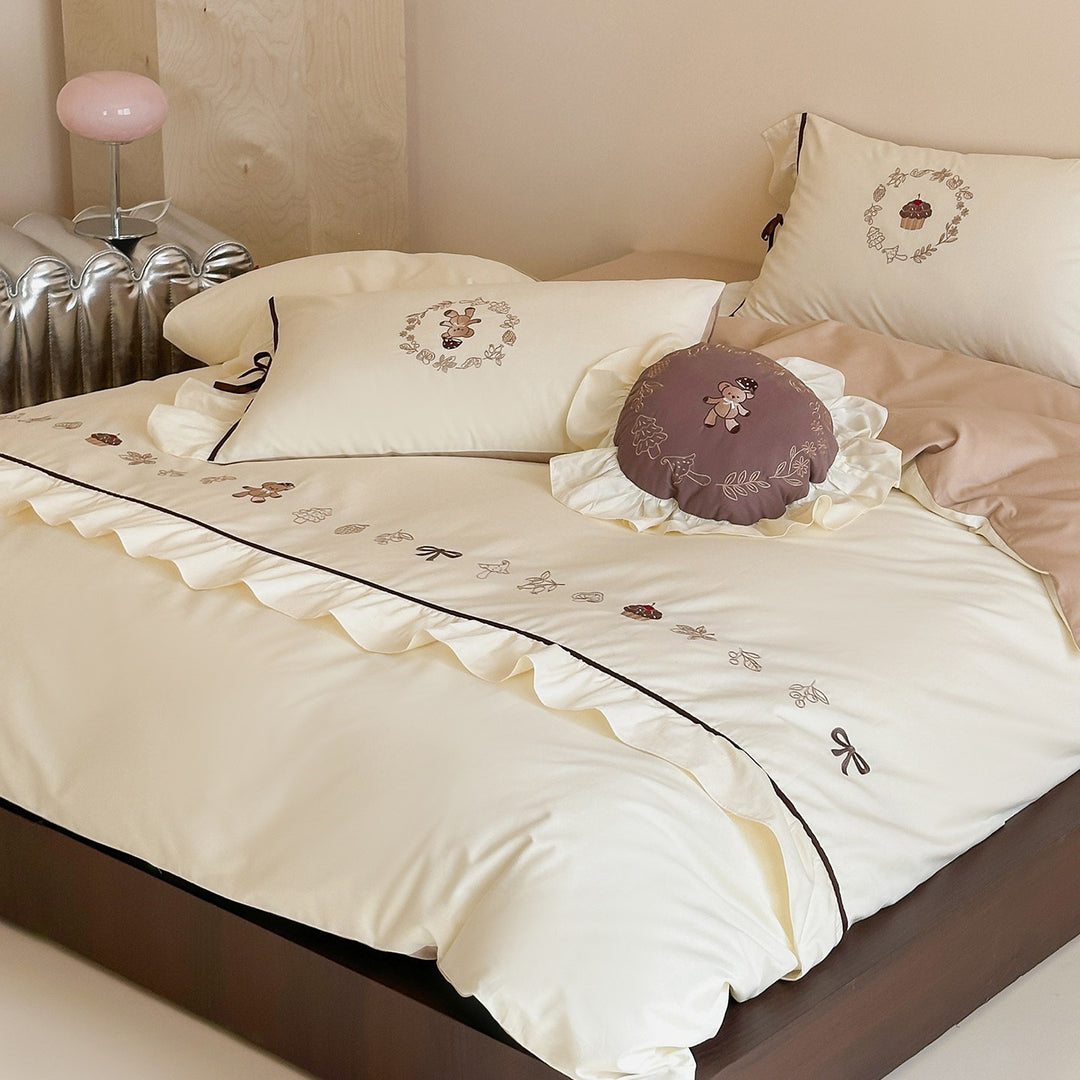 Embroidered bedding set with ruffled trim, teddy design and decorative pillow
