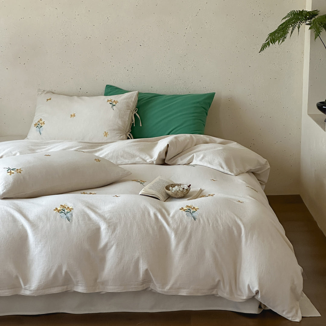 Natural linen duvet cover set with embroidered floral motifs and bow closure