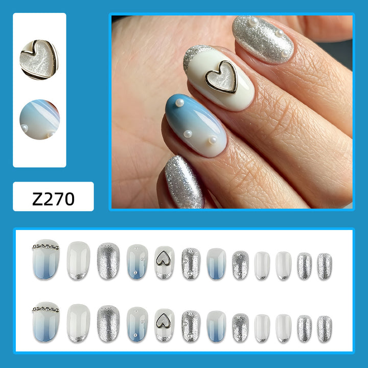 Glamorous artificial nails with heart design and pearl details Kalsten