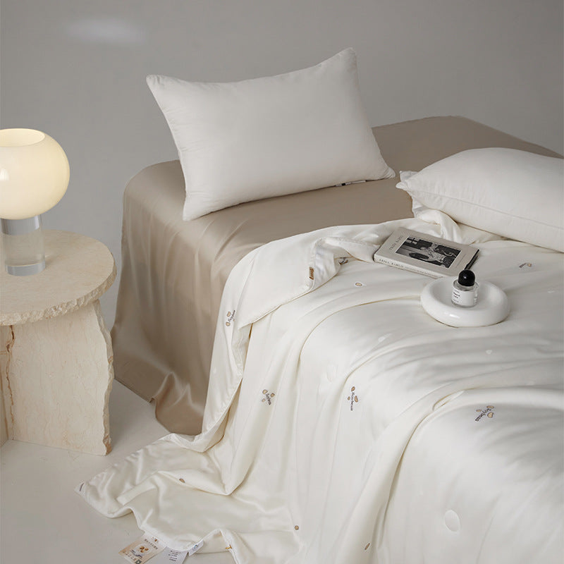 Silk bed cover made of microfiber with subtle embroidery and ultra-light fall