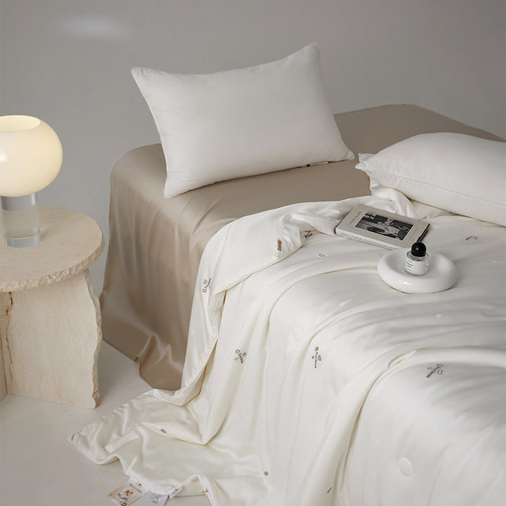 Silk bed cover made of microfiber with subtle embroidery and ultra-light fall