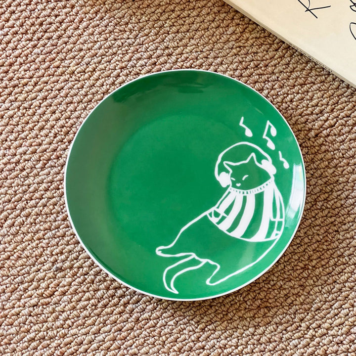Decorative ceramic plate with cat motif and green border decoration