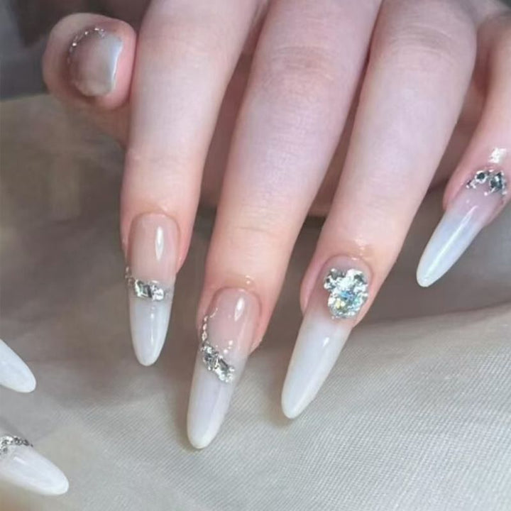 Acrylic nail set with elegant tips and glamorous rhinestone accents Kalsten