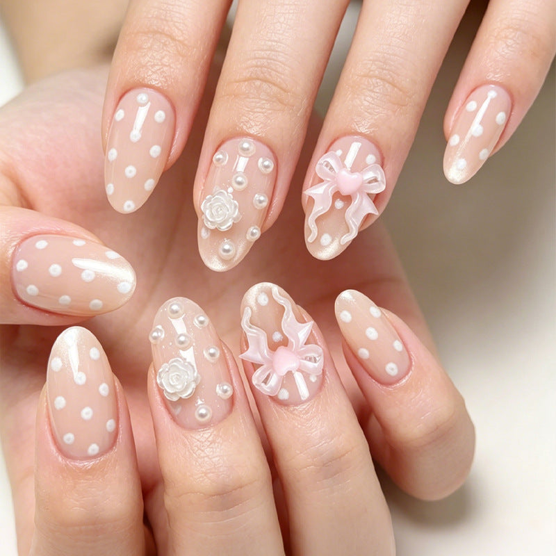 Art nail set with playful dots and romantic embellishments Kalsten