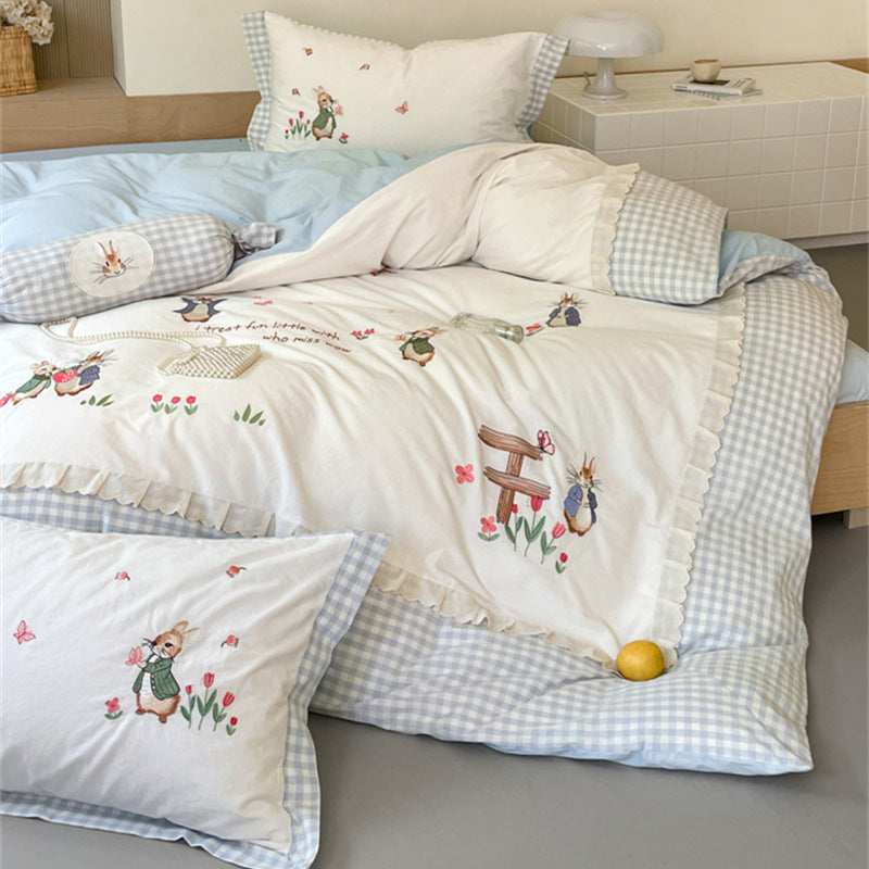 Romantic bedding set with embroidered rabbit motifs and delicate ruffles