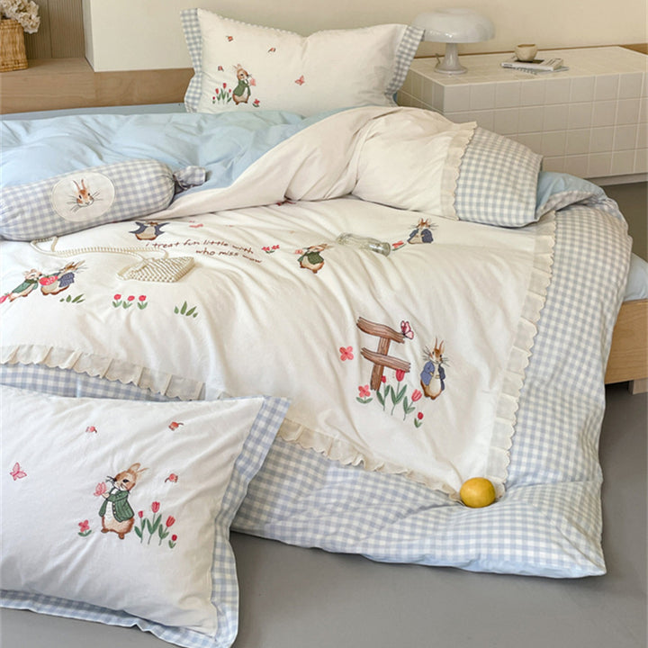 Romantic bedding set with embroidered rabbit motifs and delicate ruffles