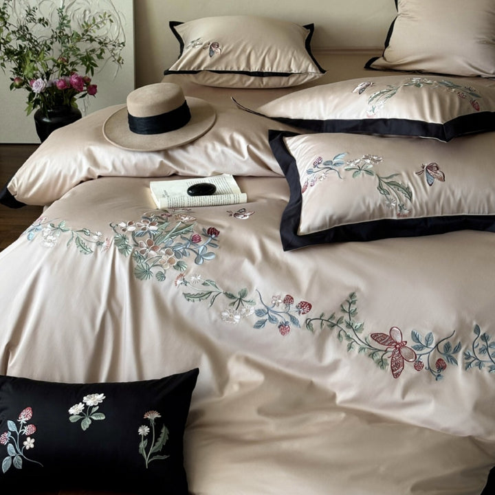 Luxurious embroidered satin bedding set with contrast piping and decorative pillow