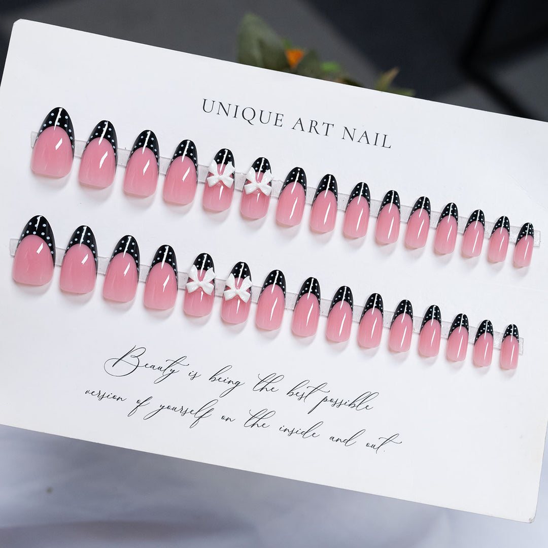 Decorative Stiletto Press-On Nail Art with Bow and Polka Dot Design