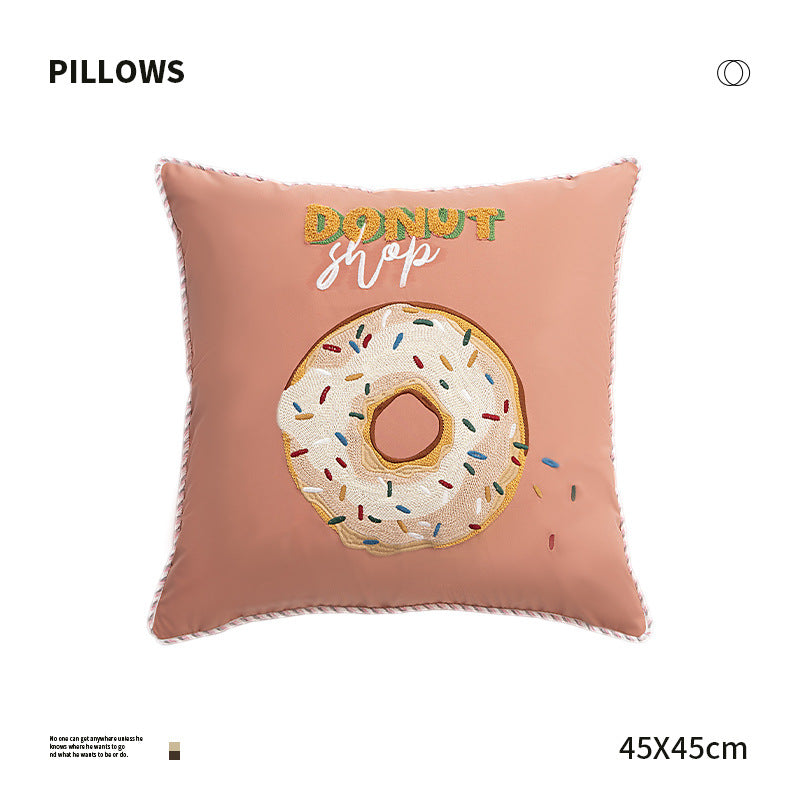 Square decorative cushion with embroidered donut motif and decorative piping edge