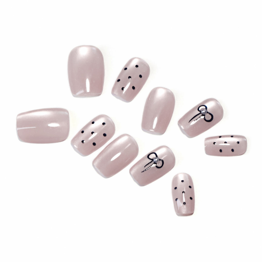 Artificial nail extensions with decorative bows and dots Kalsten