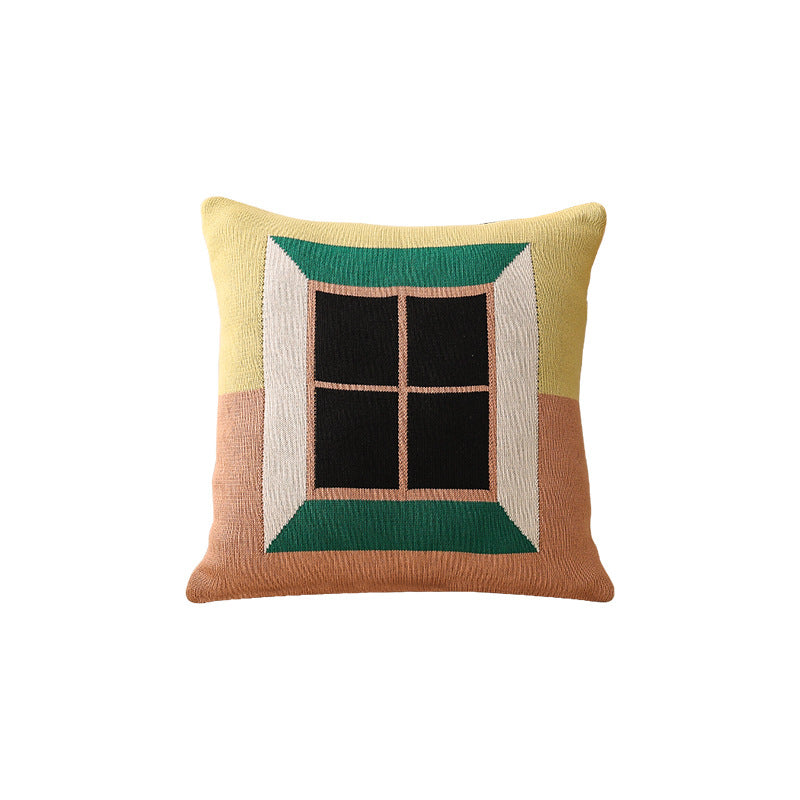 Geometric knit pillow with triangle pattern and logo patch
