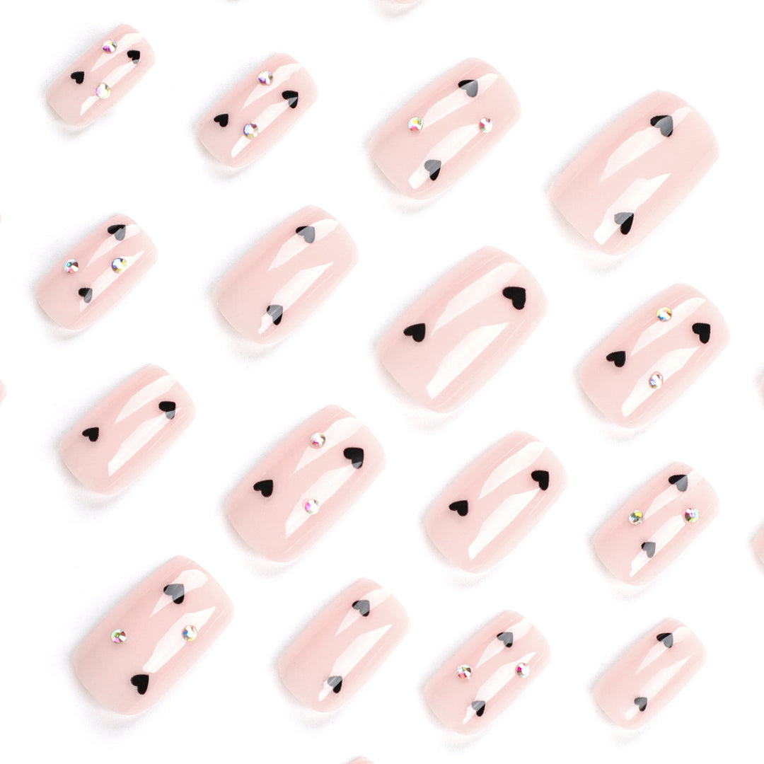 Artistic nail art with heart design and glitter accents Kalsten
