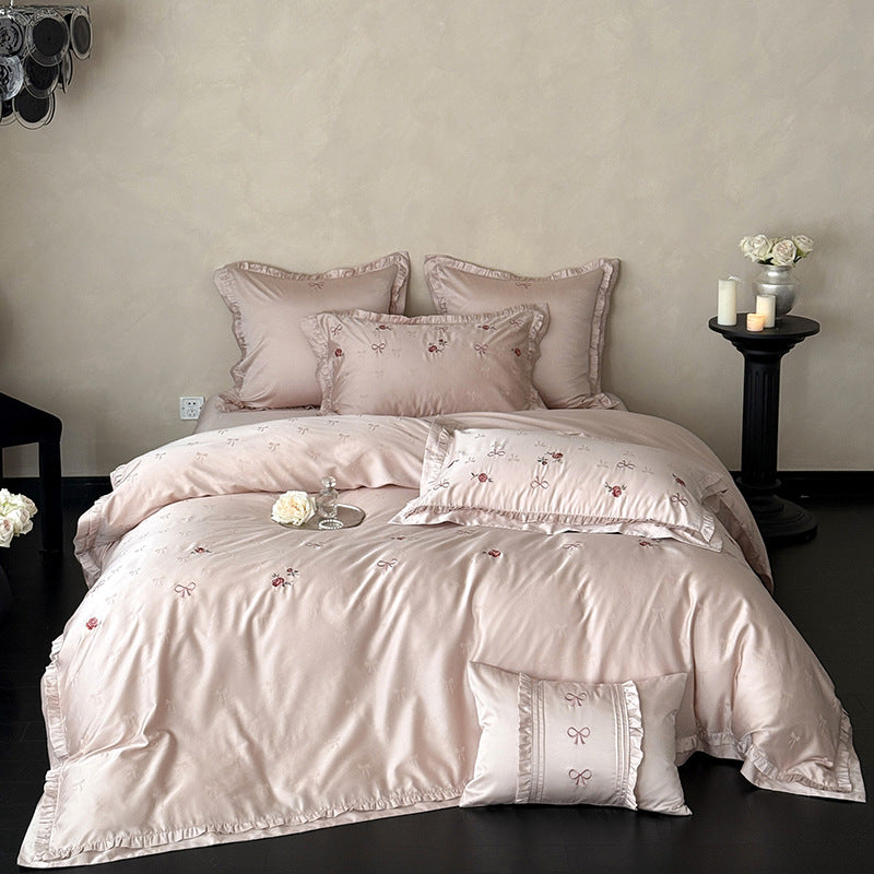 Luxurious satin bedding set with delicate floral embroidery and ruffles