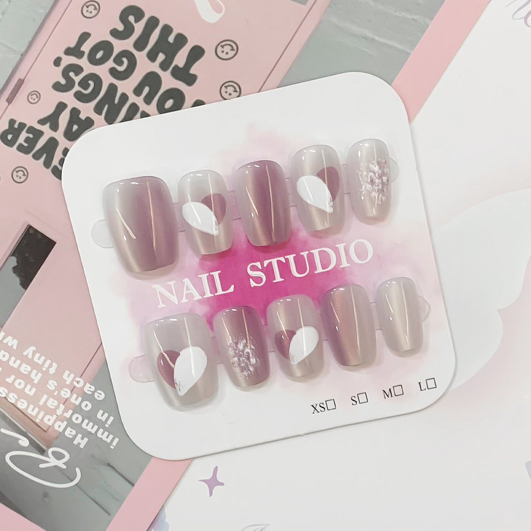 Artistic acrylic nails with heart-shaped accents Kalsten