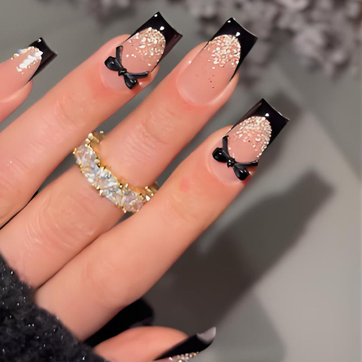 Artificial nail set with elegant glitter accents and bow details Kalsten