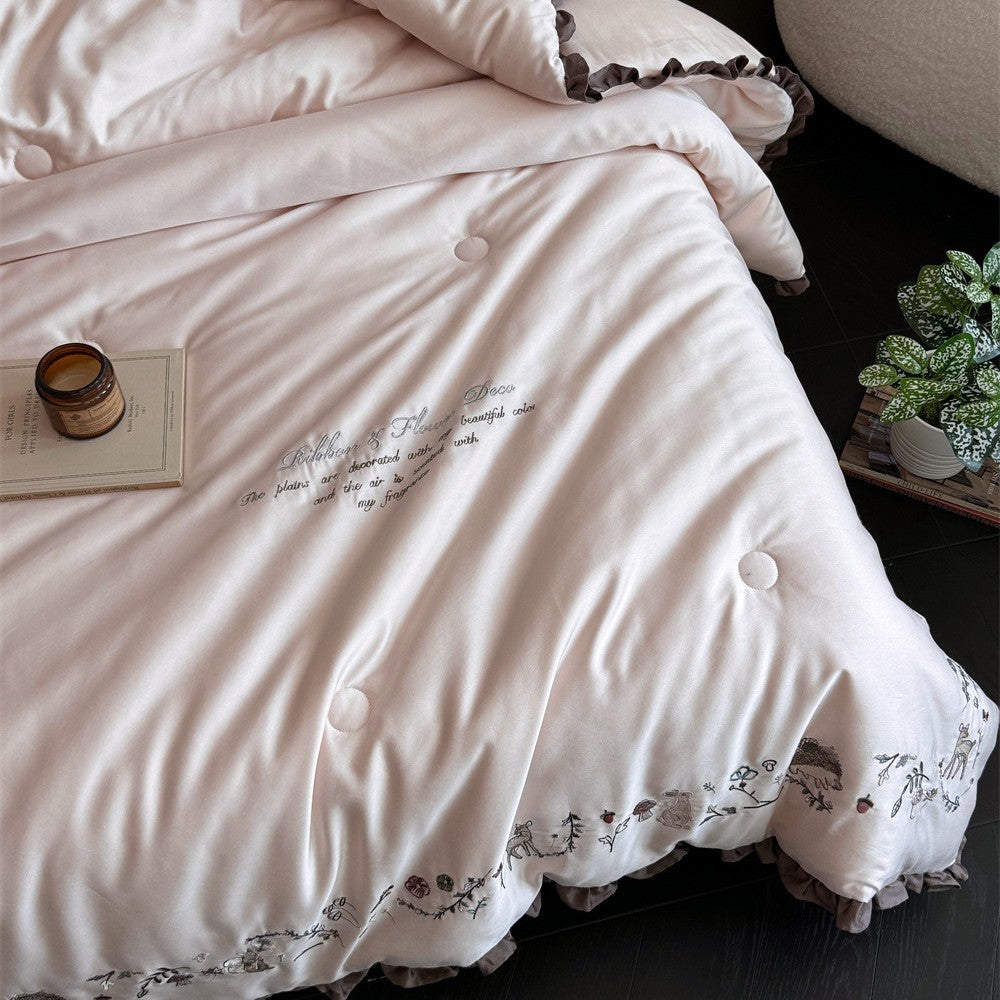 Quilted reversible duvet cover with floral embroidery and ruffled hem