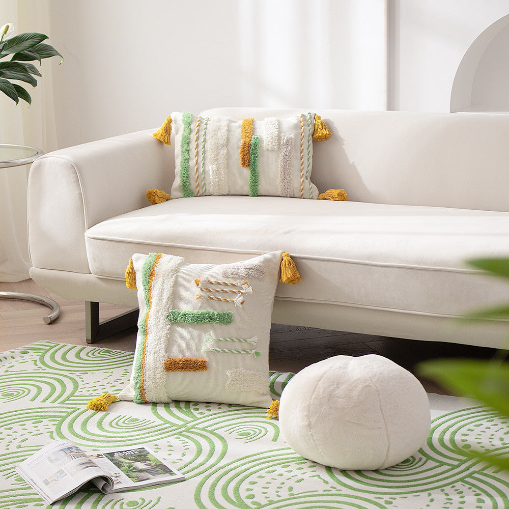 woven decorative cushion cover with tufted relief stripes and corner tassels