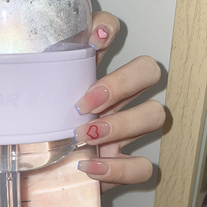 Glamorous artificial nails with heart design and glittering accents Kalsten