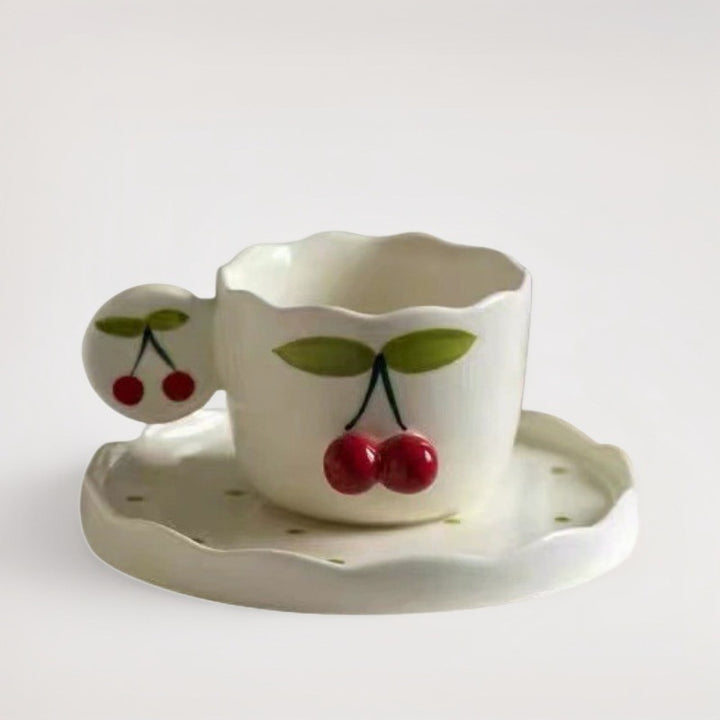 Hand-shaped espresso cup with wavy edge, round handle plate and applied cherry relief
