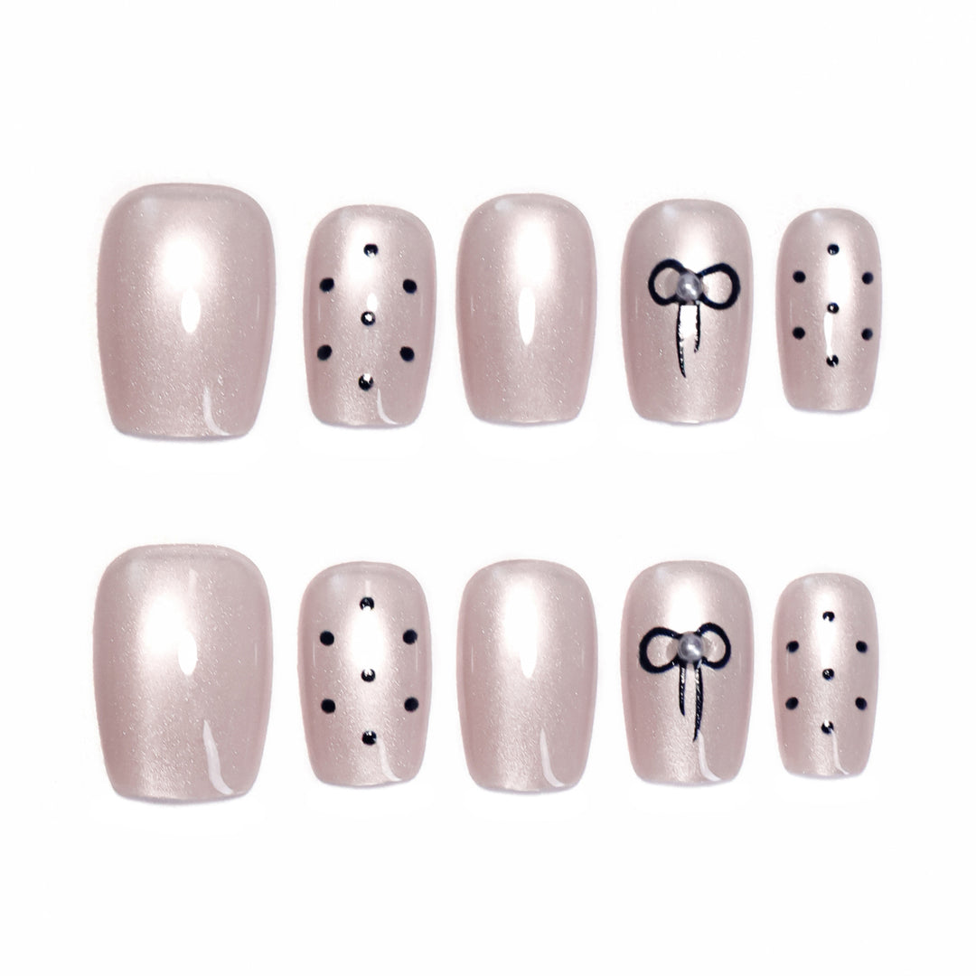 Artificial nail extensions with decorative bows and dots Kalsten