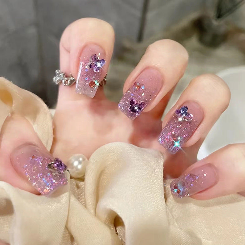 Glamorous artificial nails with glitter and floral accents Kalsten