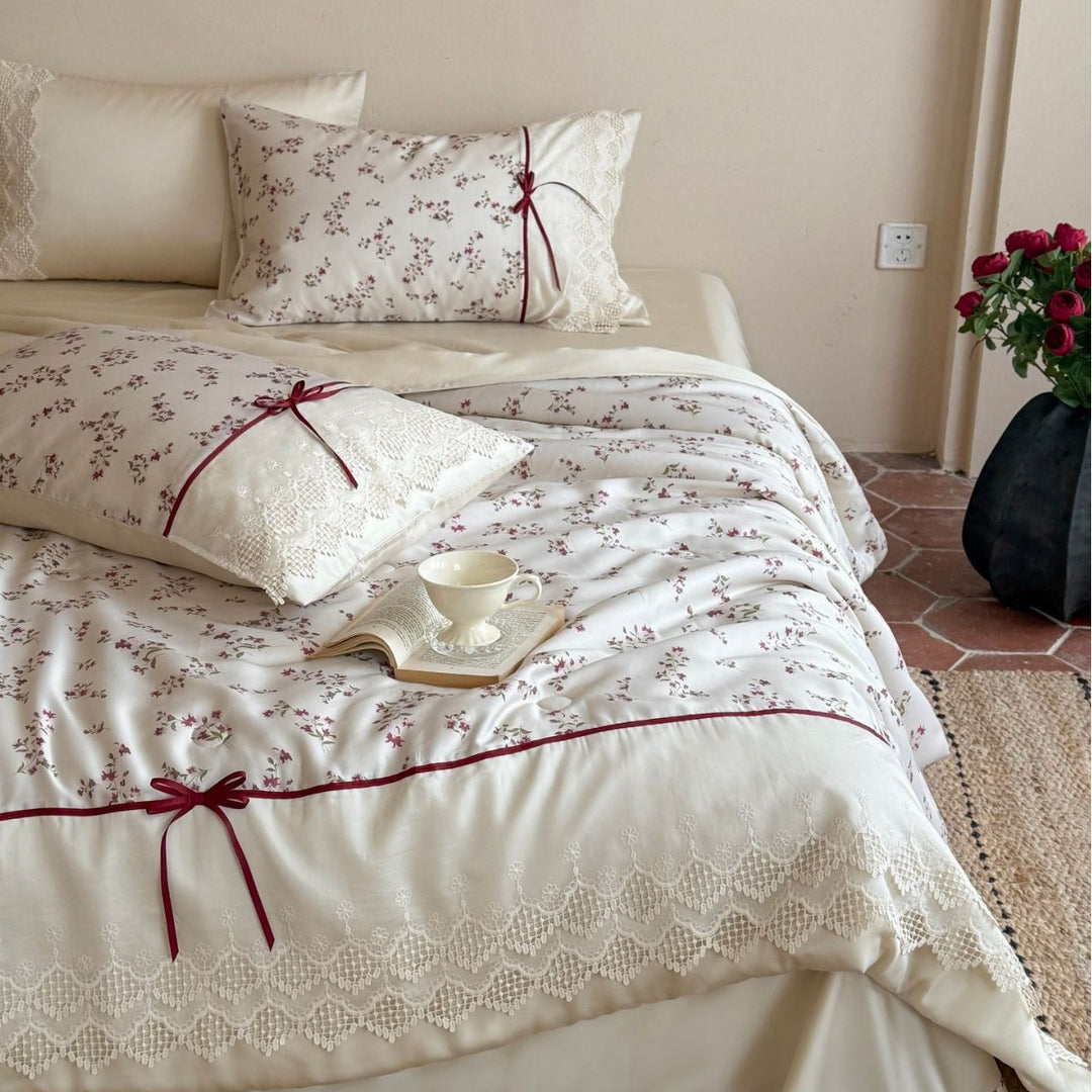 Luxurious cotton satin duvet cover set with lace trim, floral all-over embroidery, and decorative ribbons